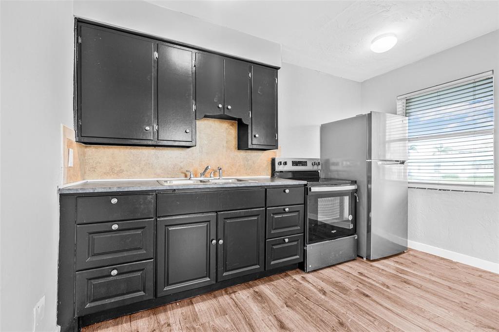 30 Lynn Way Madeira Beach, FL 33708 - Photo 5 of 16 a kitchen with a refrigerator stove and sink