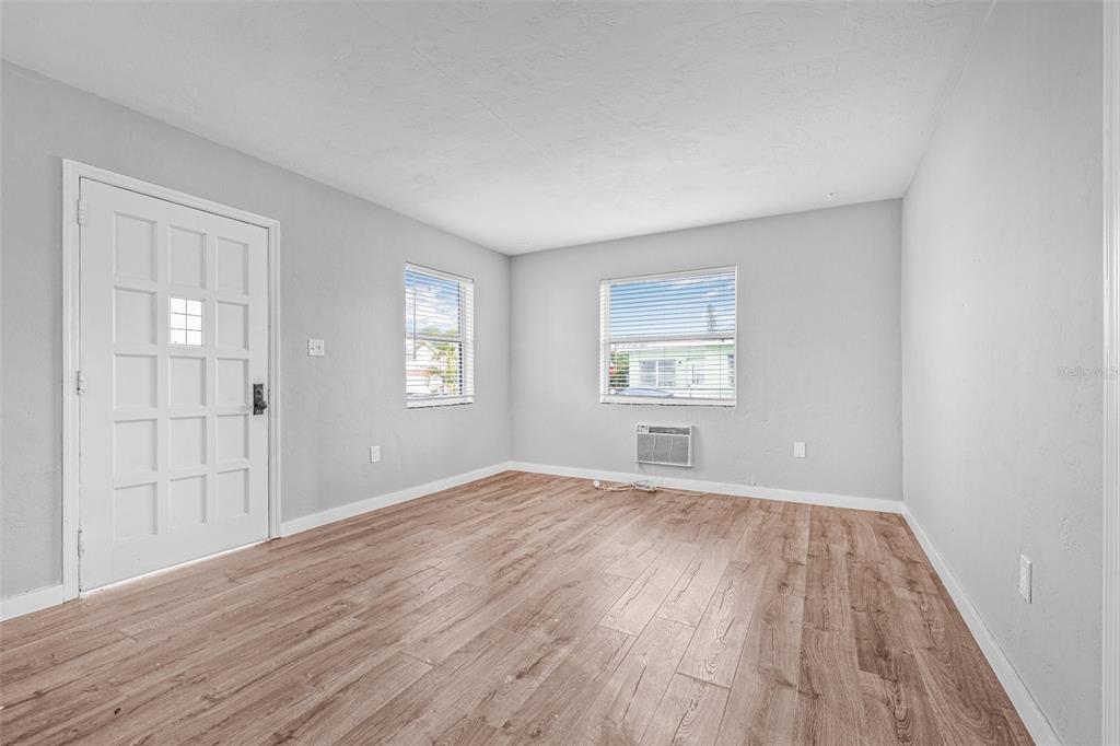 30 Lynn Way Madeira Beach, FL 33708 - Photo 6 of 16 wooden floor in an empty room with a window