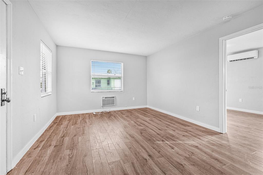 30 Lynn Way Madeira Beach, FL 33708 - Photo 7 of 16 an empty room with wooden floor and windows