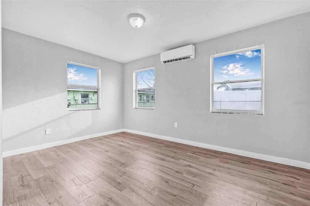 30 Lynn Way Madeira Beach, FL 33708 - Photo 8 of 16 wooden floor in an empty room with a window