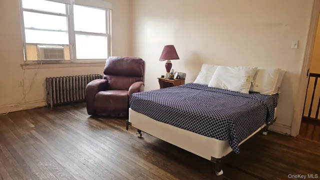 a spacious bedroom with a bed and a flat screen tv