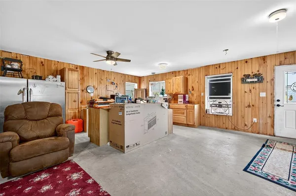 a living room with furniture and kitchen view