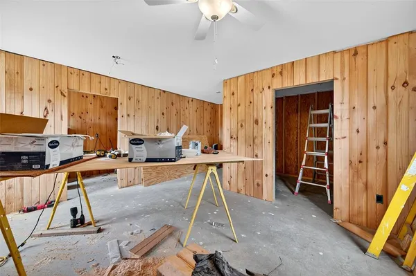 a view of a kitchen with kitchen island stainless steel appliances wooden floor and furniture
