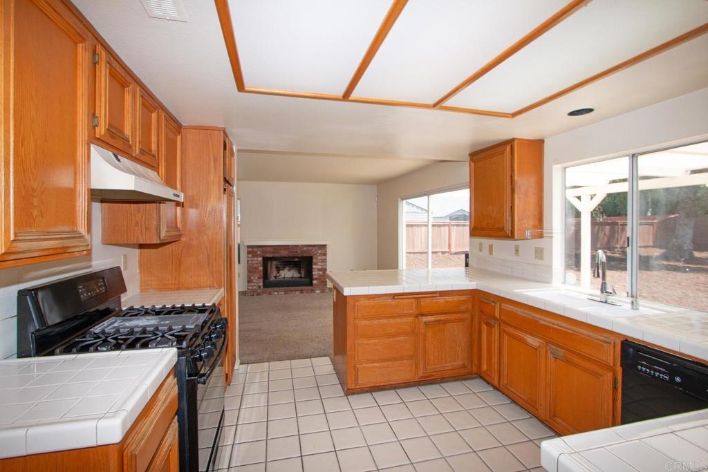 800 Foxwood Drive Oceanside, CA 92057 - Photo 9 of 33 a kitchen with a sink stove and cabinets