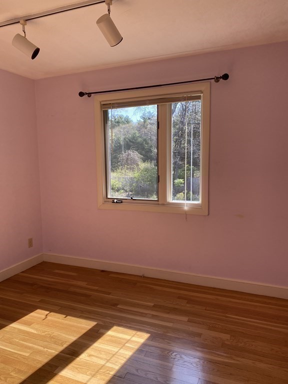 490 Concord Road Sudbury, MA 01776 - Photo 22 of 31 a view of an empty room with wooden floor and a window