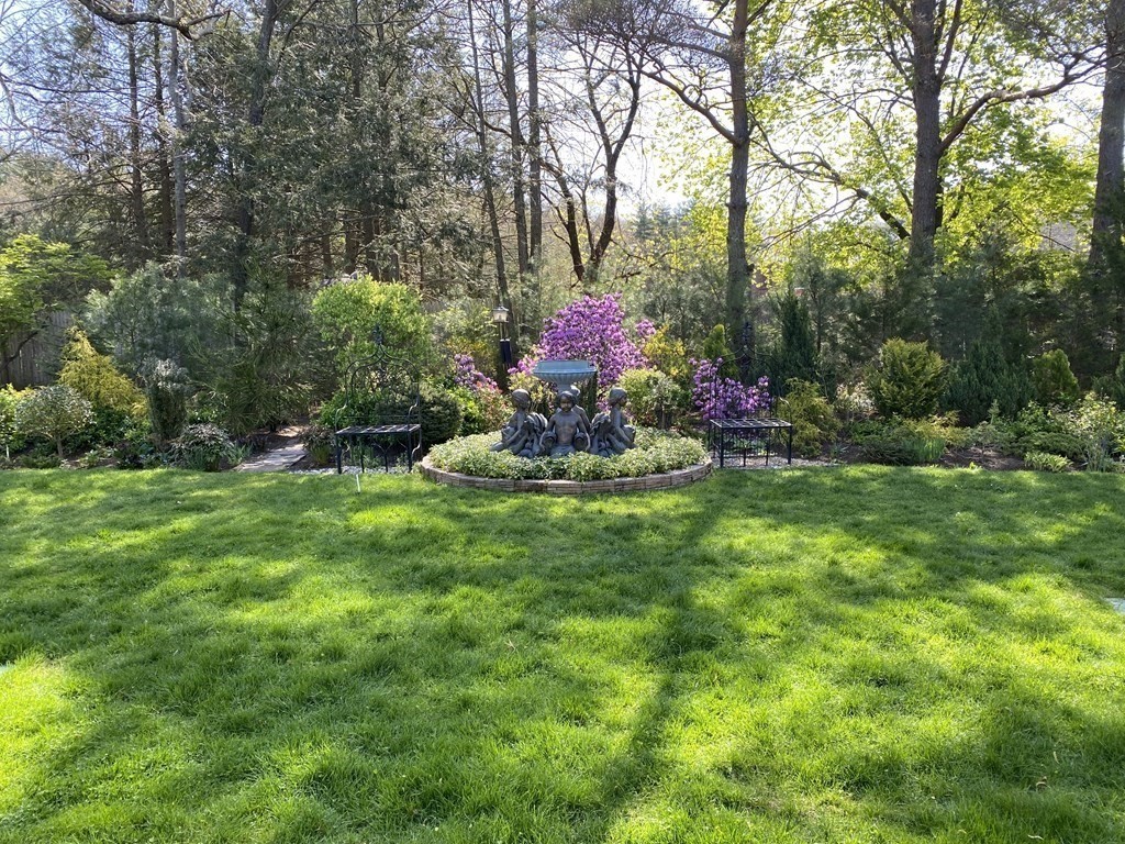 490 Concord Road Sudbury, MA 01776 - Photo 29 of 31 a front view of a house with a yard and fountain in middle