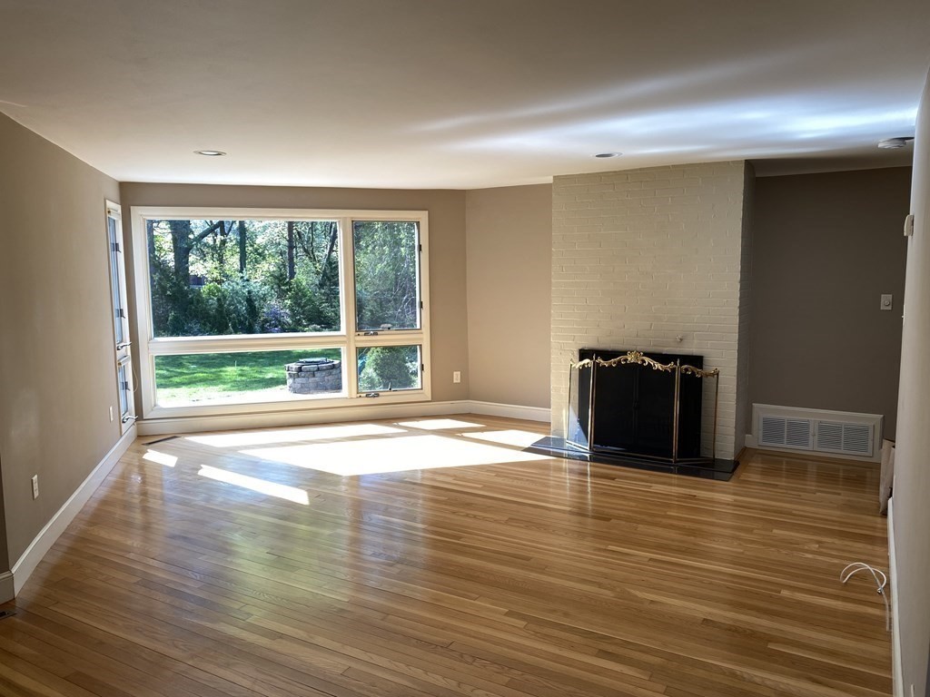 490 Concord Road Sudbury, MA 01776 - Photo 3 of 31 a view of empty room with wooden floor and floor to ceiling window
