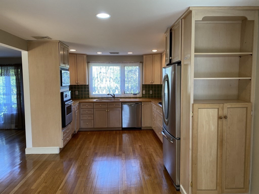 490 Concord Road Sudbury, MA 01776 - Photo 9 of 31 a kitchen with a refrigerator and a sink