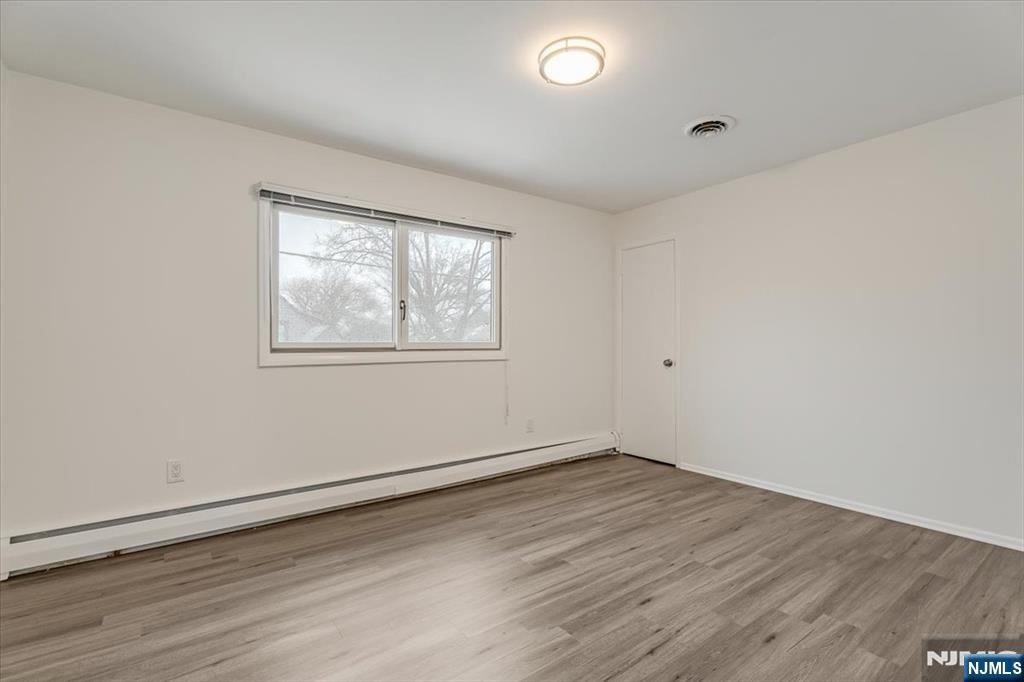 35 Field Road, Unit 2 Maplewood, NJ 07040 - Photo 11 of 13 an empty room with wooden floor and windows