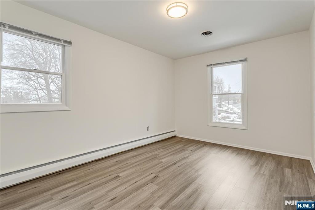 35 Field Road, Unit 2 Maplewood, NJ 07040 - Photo 12 of 13 an empty room with wooden floor and windows