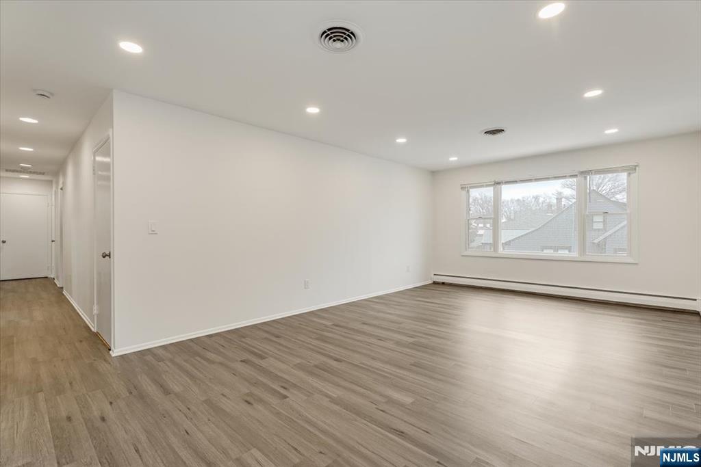 35 Field Road, Unit 2 Maplewood, NJ 07040 - Photo 2 of 13 an empty room with wooden floor and window