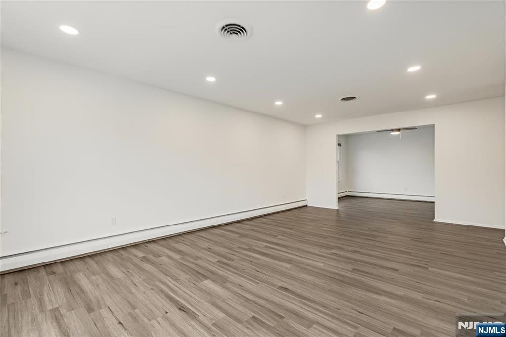 35 Field Road, Unit 2 Maplewood, NJ 07040 - Photo 4 of 13 an empty room with wooden floor and windows