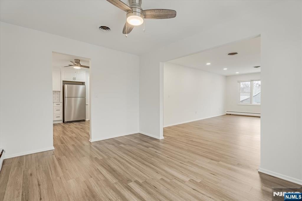 35 Field Road, Unit 2 Maplewood, NJ 07040 - Photo 5 of 13 an empty room with wooden floor and windows
