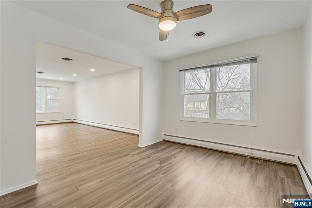 35 Field Road, Unit 2 Maplewood, NJ 07040 - Photo 9 of 13 wooden floor in an empty room with a window