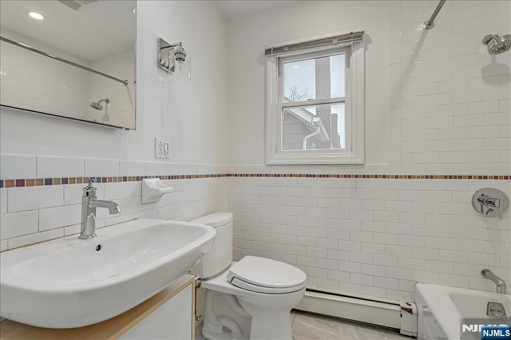 35 Field Road, Unit 2 Maplewood, NJ 07040 - Photo 10 of 13 a bathroom with a sink a toilet and vanity