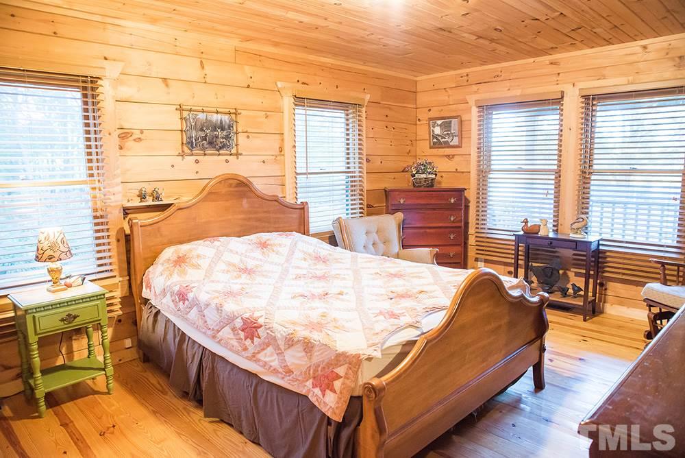 3520 Bowmantown Road Roxboro, NC 27574 - Photo 16 of 24 a bed sitting in a bedroom next to a larger window