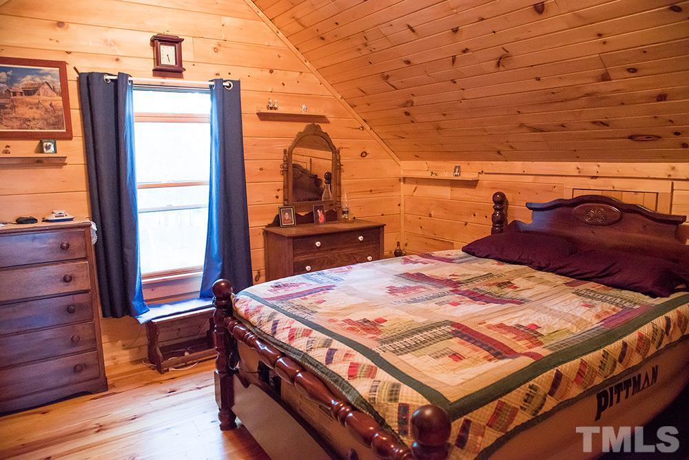 3520 Bowmantown Road Roxboro, NC 27574 - Photo 22 of 24 a bed sitting in a bedroom next to a window with pc on the table