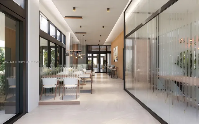 a view of a hallway with dining area and chandelier