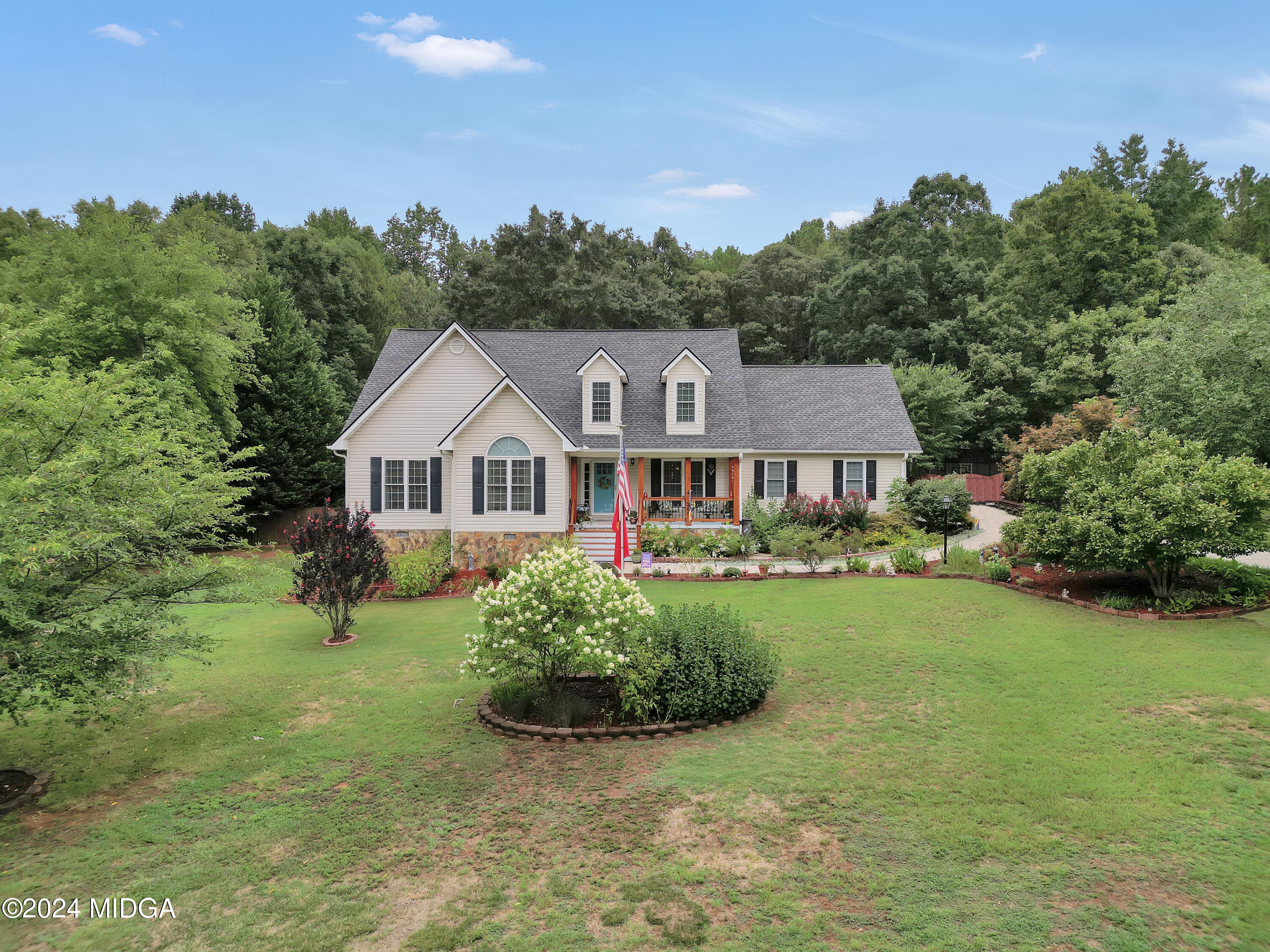 208 Brown Branch Road Locust Grove, GA 30248 - Photo 1 of 44 a front view of a house with garden