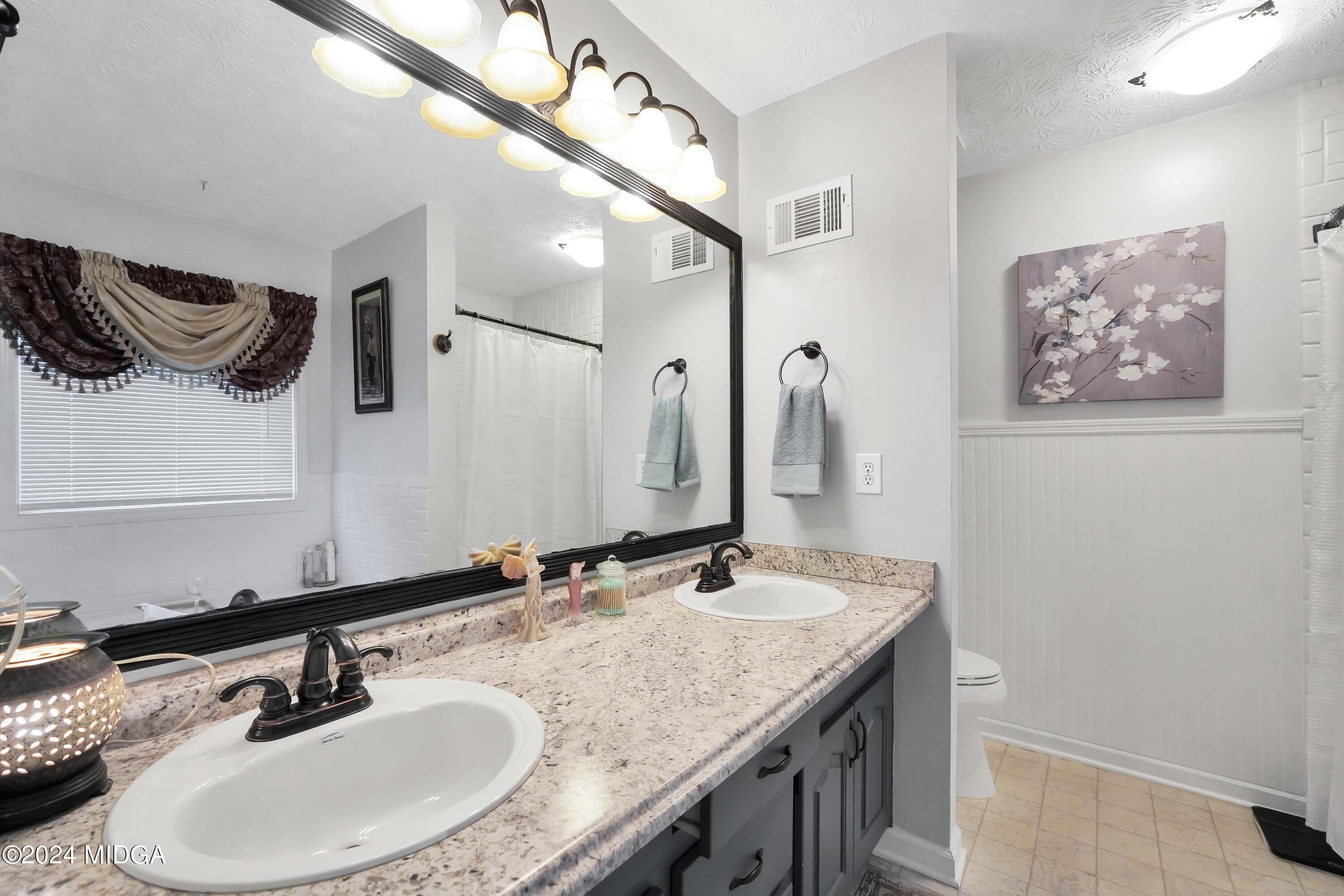 208 Brown Branch Road Locust Grove, GA 30248 - Photo 18 of 44 a bathroom with a sink and a mirror