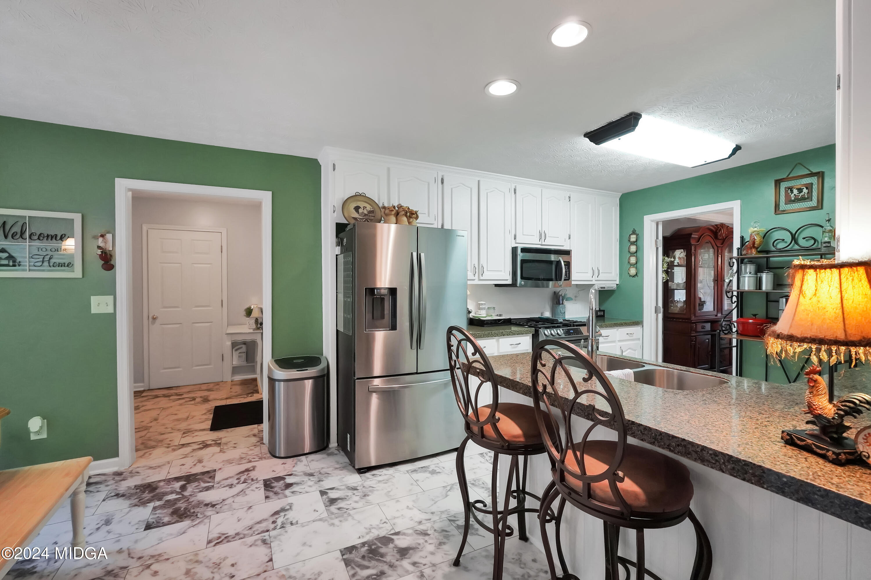 208 Brown Branch Road Locust Grove, GA 30248 - Photo 23 of 44 a kitchen with stainless steel appliances a refrigerator and a stove top oven