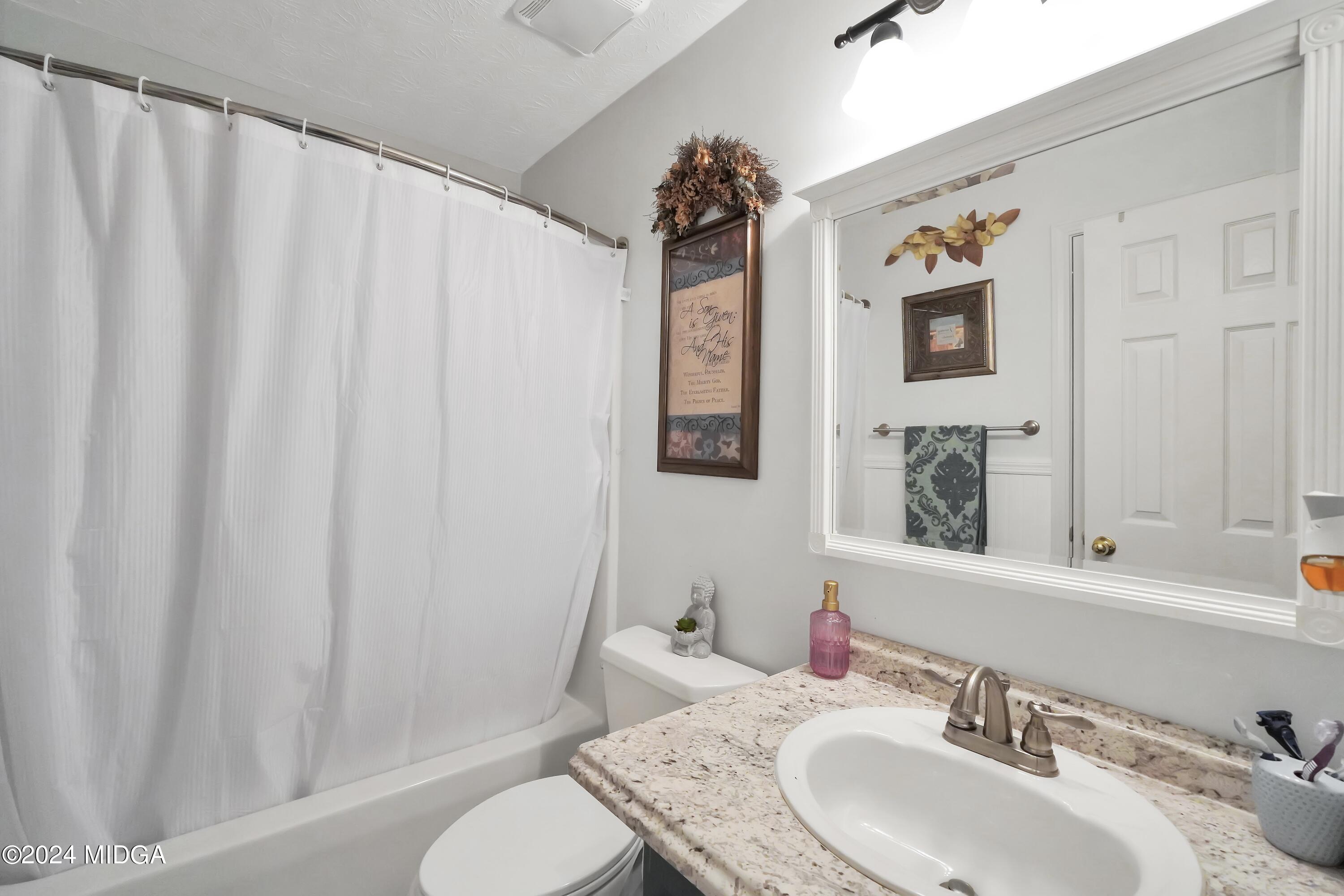 208 Brown Branch Road Locust Grove, GA 30248 - Photo 33 of 44 a bathroom with a granite countertop sink and a mirror