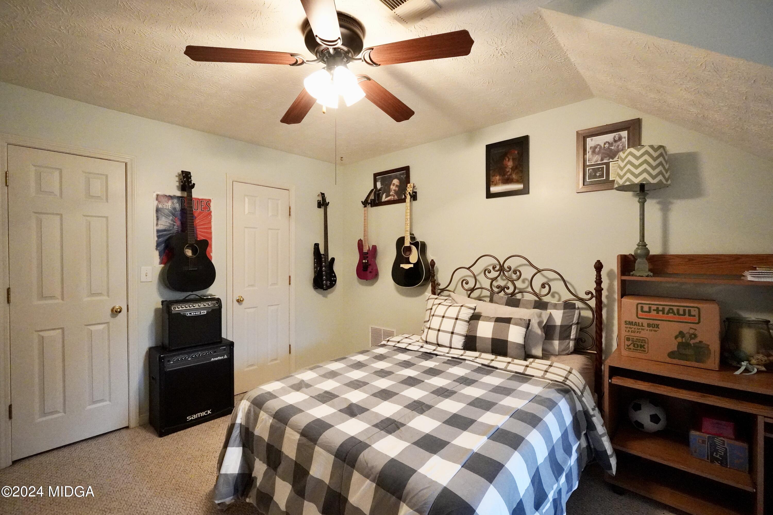 208 Brown Branch Road Locust Grove, GA 30248 - Photo 34 of 44 a bedroom with a bed and a lamp on dresser