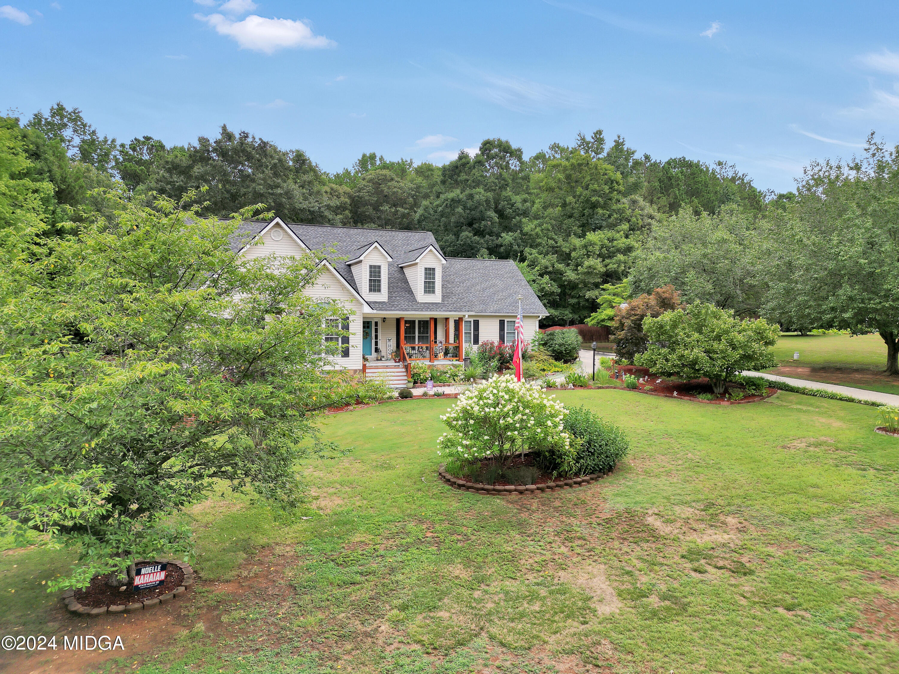 208 Brown Branch Road Locust Grove, GA 30248 - Photo 4 of 44 a front view of a house with a garden