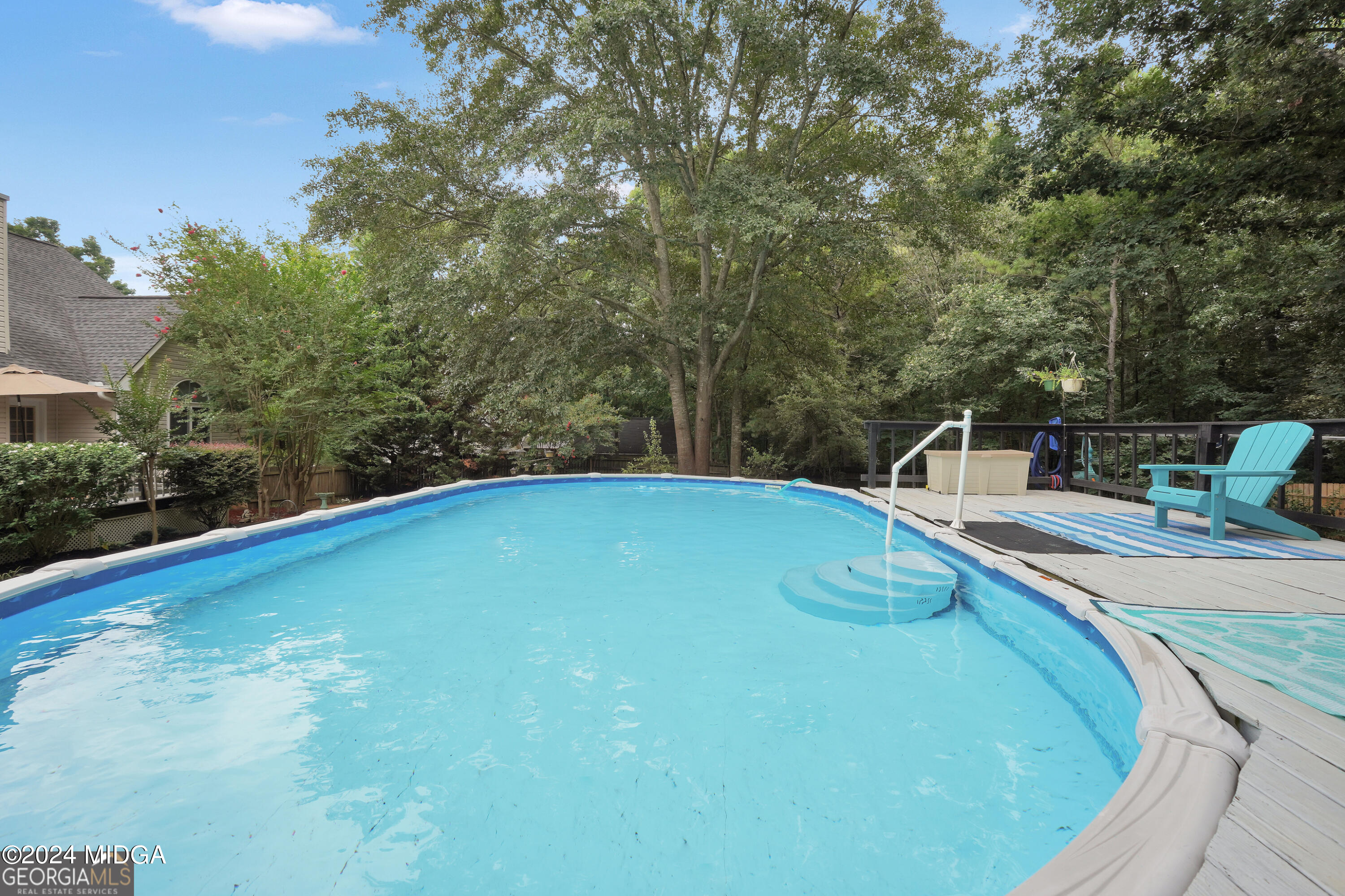 208 Brown Branch Road Locust Grove, GA 30248 - Photo 41 of 44 a view of a swimming pool with a chair and tables