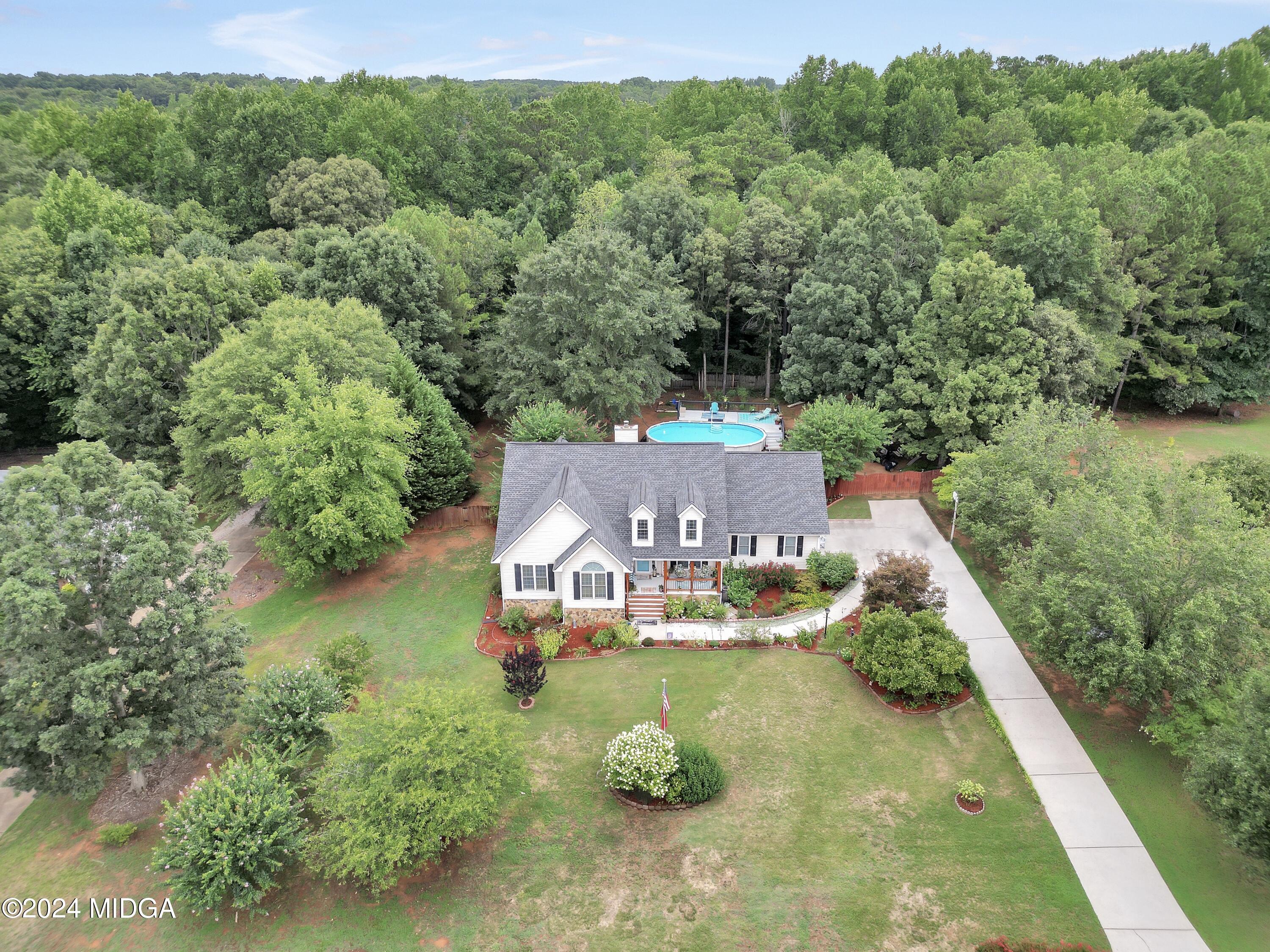 208 Brown Branch Road Locust Grove, GA 30248 - Photo 6 of 44 an aerial view of a house with pool outdoor seating yard and mountain view