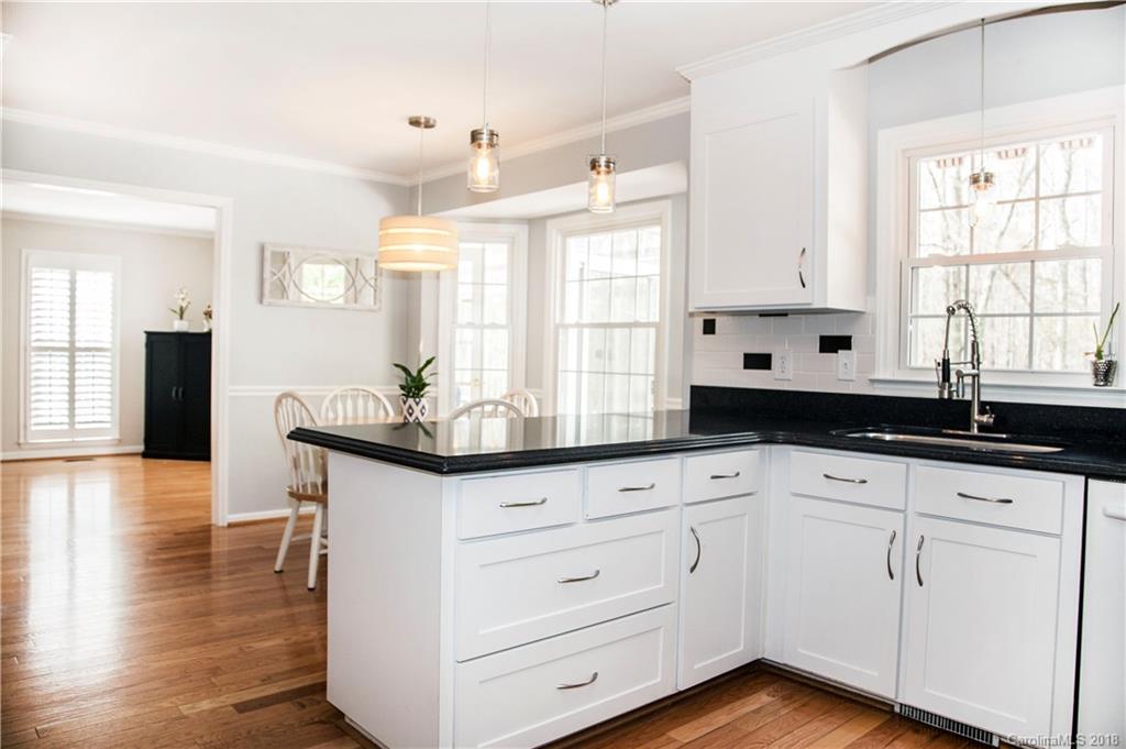 2751 Farmstead Lane, Unit 63 Fort Mill, SC 29708 - Photo 11 of 30 a kitchen with granite countertop white cabinets white appliances and a large window