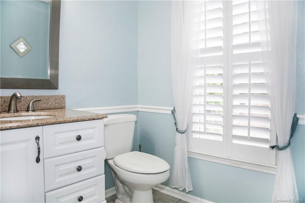 2751 Farmstead Lane, Unit 63 Fort Mill, SC 29708 - Photo 12 of 30 a bathroom with a granite countertop toilet sink and mirror