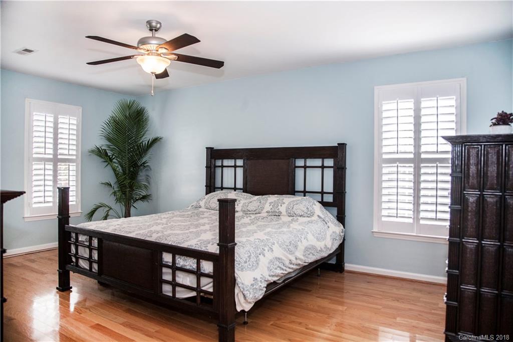 2751 Farmstead Lane, Unit 63 Fort Mill, SC 29708 - Photo 13 of 30 a bedroom with a bed chandelier and a window