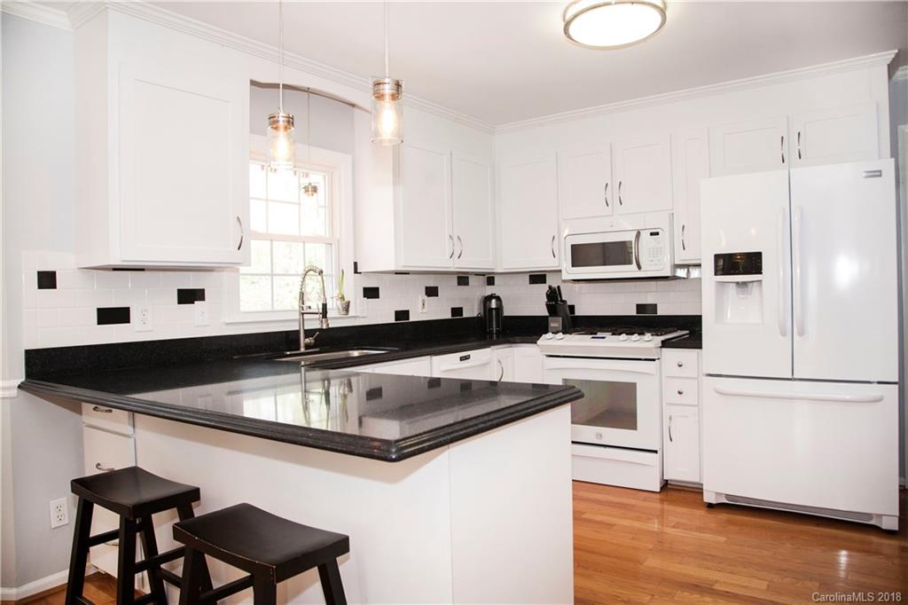 2751 Farmstead Lane, Unit 63 Fort Mill, SC 29708 - Photo 10 of 30 a kitchen with stainless steel appliances granite countertop a sink a stove and a refrigerator