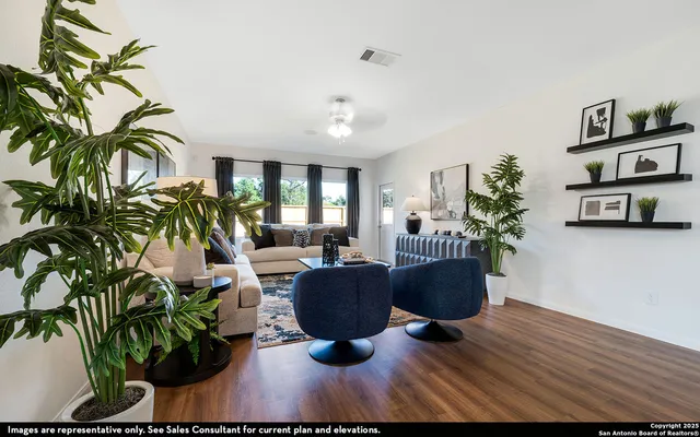 a living room with furniture and a potted plant
