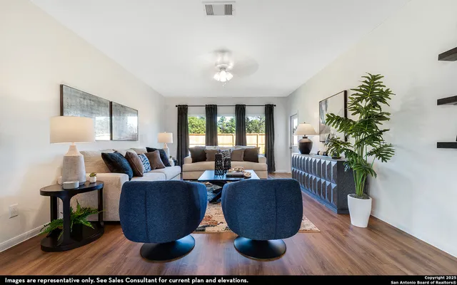 a living room with furniture potted plant and a lamp