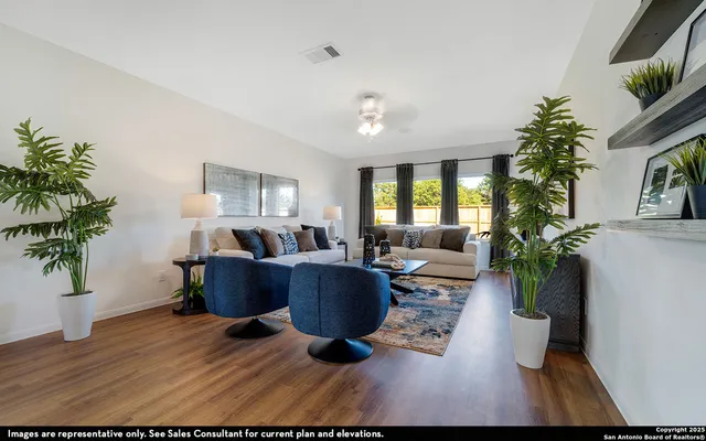 a living room with furniture potted plant and a window