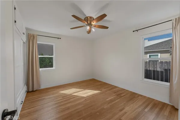 a view of a room with a ceiling fan