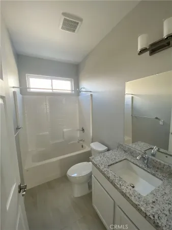 a view of a patio with a table and chairs under an umbrella