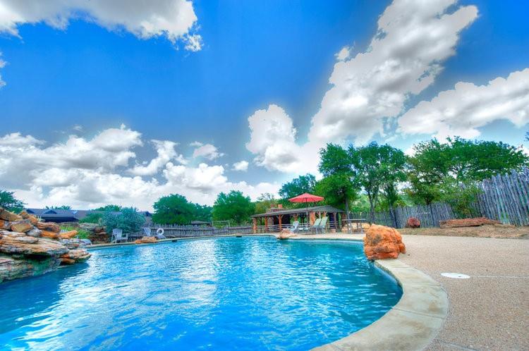 Tbd Stagecoach Trail Gordon, TX 76453 - Photo 32 of 35 a swimming pool with outdoor seating and barbeque oven