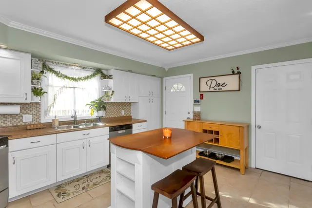 a kitchen with stainless steel appliances granite countertop a stove a sink dishwasher and a refrigerator