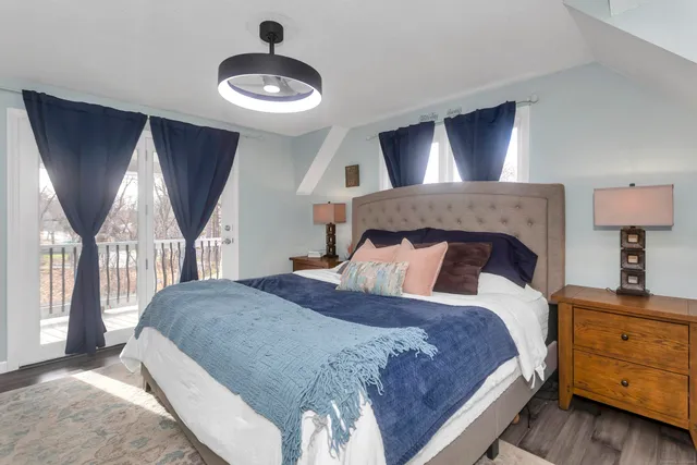 a bedroom with a large bed and a window