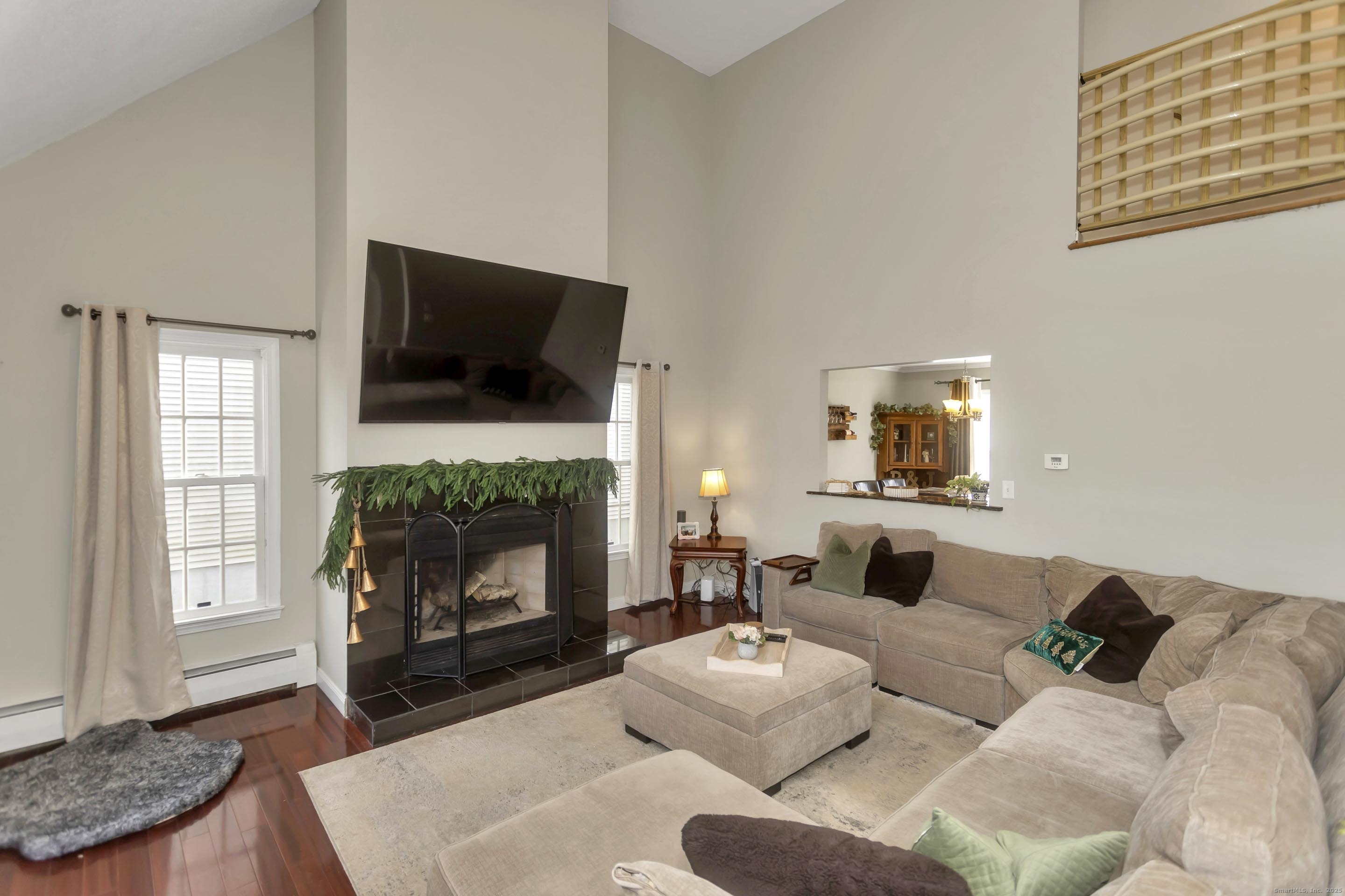 21 Brentwood Street Springfield, MA 01108 - Photo 2 of 40 a living room with furniture a fireplace and a flat screen tv