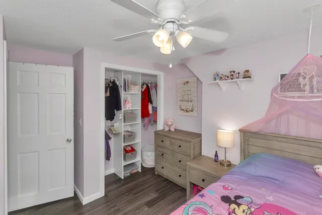 a view of a bedroom with bed and workspace
