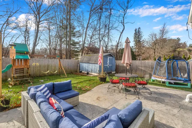 a backyard of a house with table and chairs