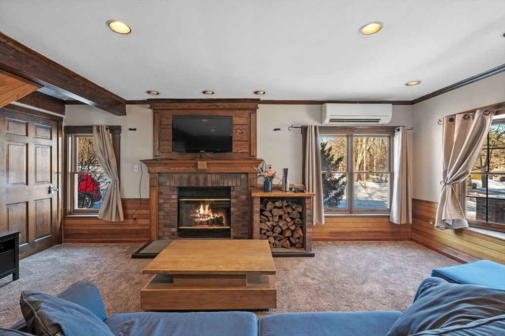 88 Squannacook Road Shirley, MA 01464 - Photo 20 of 39 a living room with furniture a flat screen tv and a fireplace