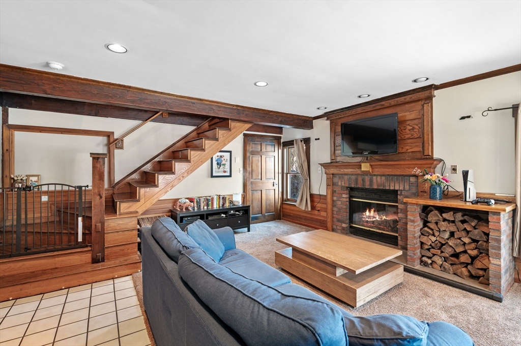 88 Squannacook Road Shirley, MA 01464 - Photo 21 of 39 a living room with furniture a flat screen tv and a fireplace