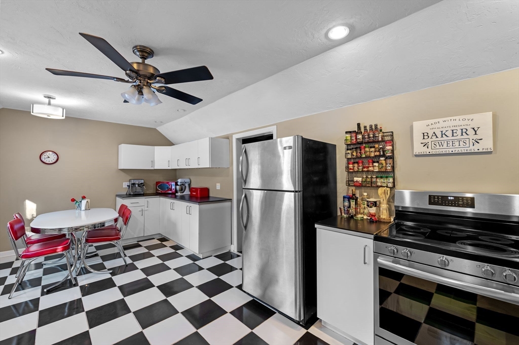 88 Squannacook Road Shirley, MA 01464 - Photo 25 of 39 a kitchen with a refrigerator and a stove top oven