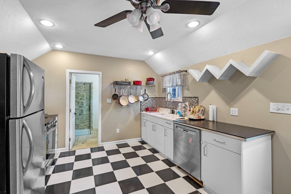 88 Squannacook Road Shirley, MA 01464 - Photo 26 of 39 a kitchen with stainless steel appliances a sink a stove a refrigerator and cabinets