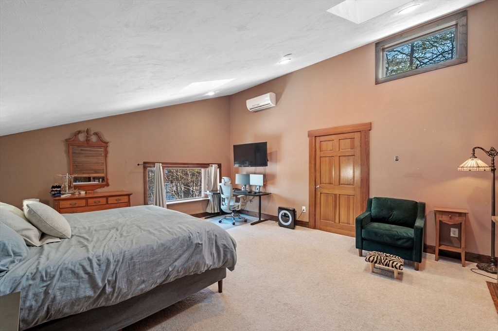 88 Squannacook Road Shirley, MA 01464 - Photo 36 of 39 a spacious bedroom with a bed a couch and large window